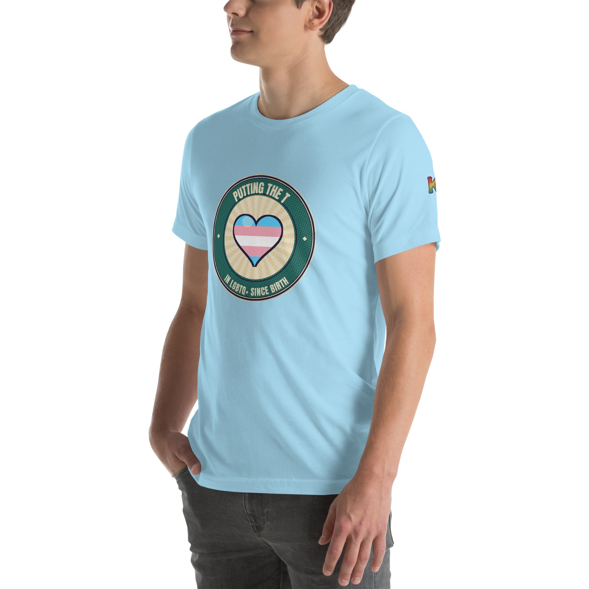 transgender pride t-shirt — Putting the T badge design, ocean blue tee left-front angled view (sleeve K visible)